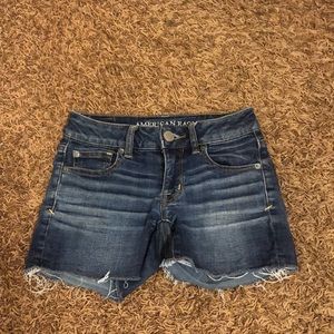Dark washed jean shorts with fringe at the bottom!
